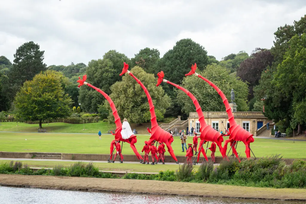 Annual report cover image featuring large puppet giraffes